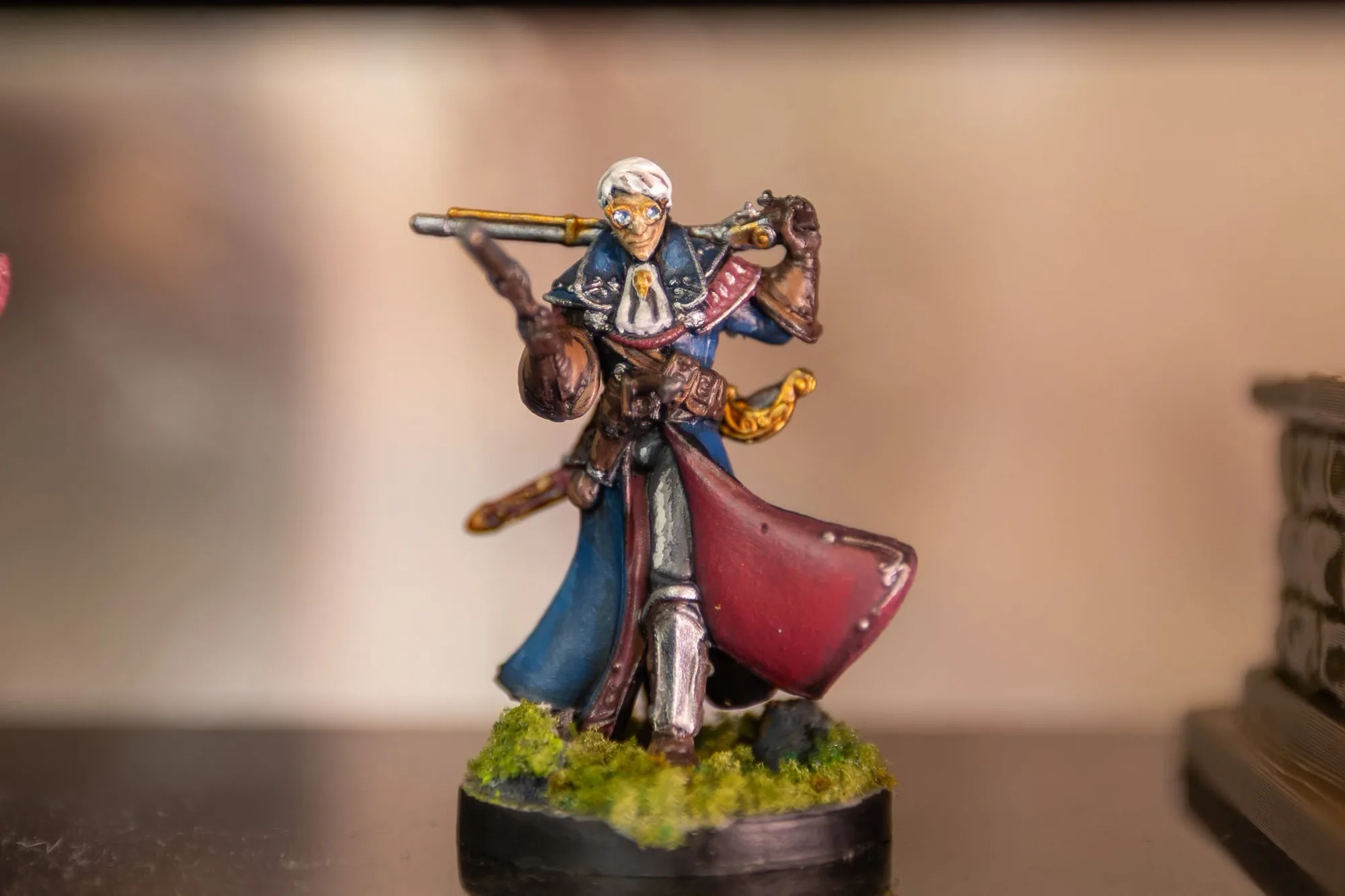 A miniature painted at the shop: a figure in a blue coat and red cape with a musket